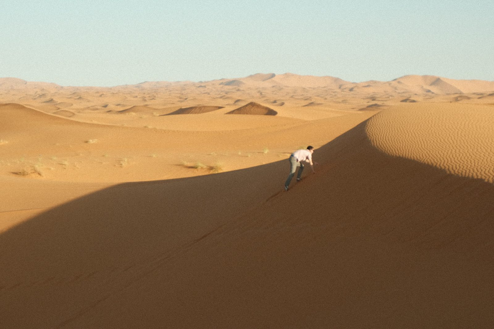 Isaac climbing a sand dune in the Sahara